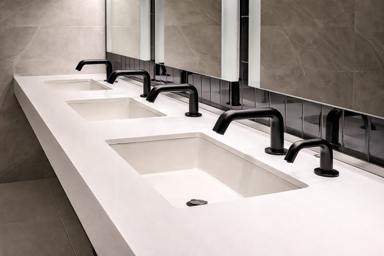 Durable all-metal commercial faucet hardware installed in an airport staff restroom or service zone